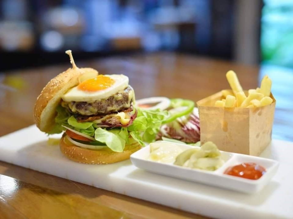 A burger & fries with dips served at Maitria Mode Sukhumvit