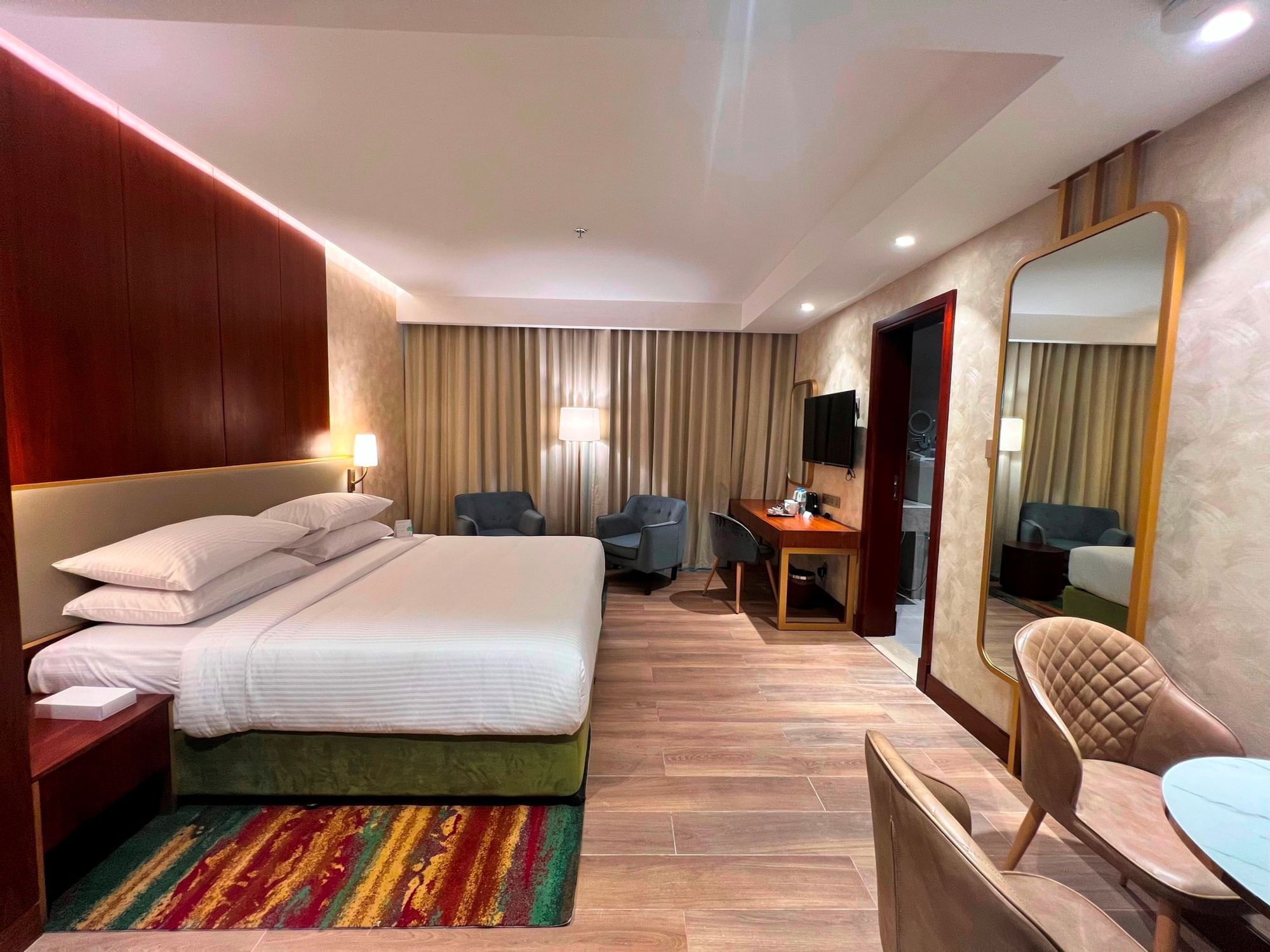 Bed & living area in Executive Studios at City Seasons Hotels