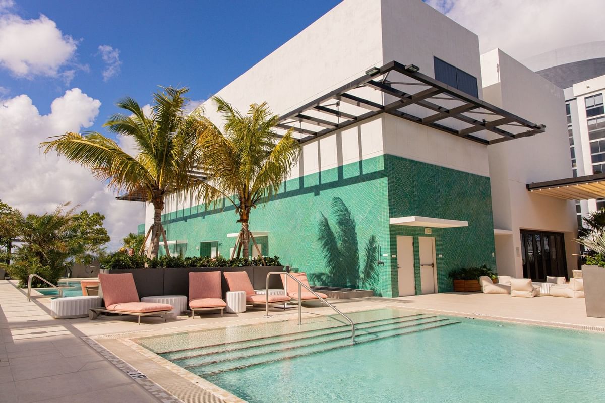 Expansive rooftop pool with jacuzzi and cabanas
