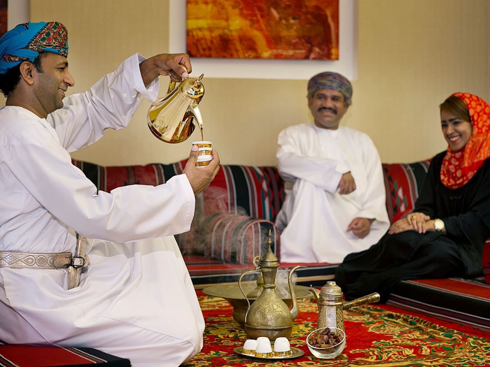 Man gracefully pours tea for a couple at City Seasons Hotels