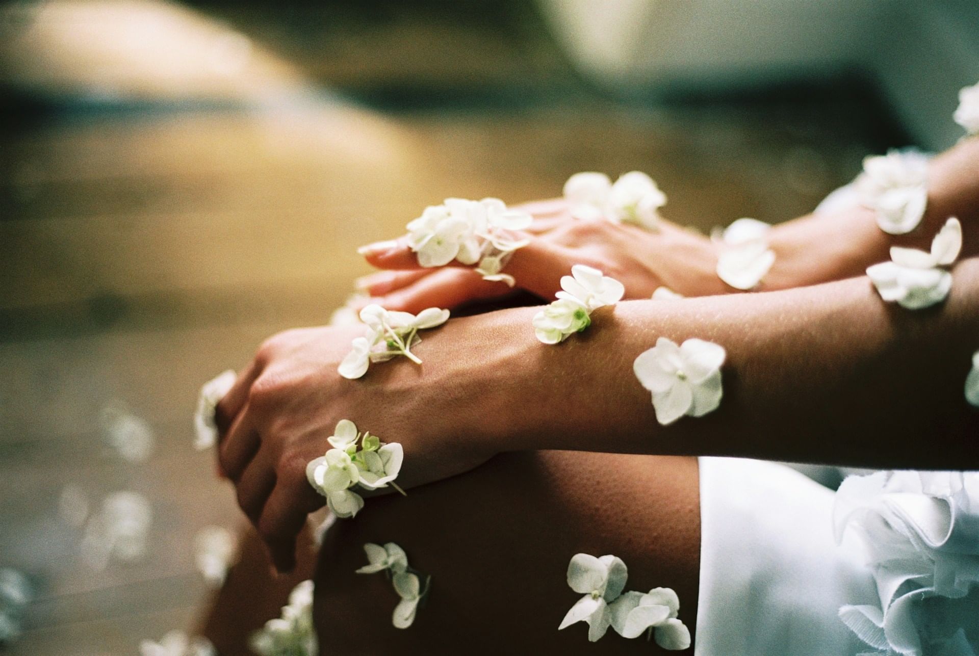 Two hands with delicate white flowers on a blurred background at Starling Hotels in Lausanne Switzerland