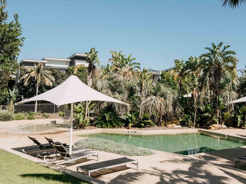 Outdoor Rock Pools with arranged sunbeds at Pullman Magenta Shores