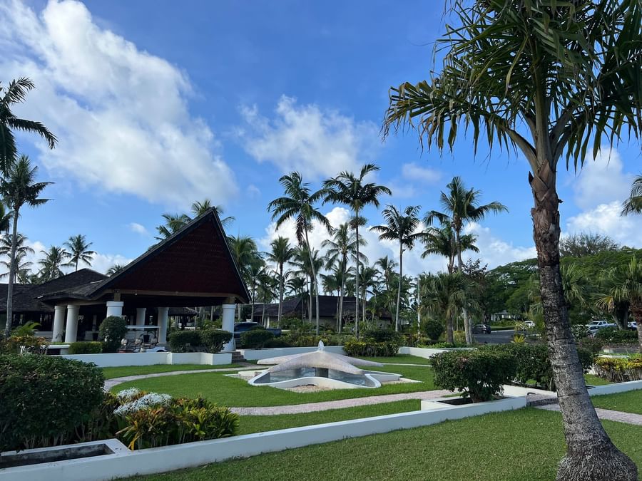 Tropical garden view with palm trees and star-shaped fountain at Warwick Le Lagon Vanuatu.