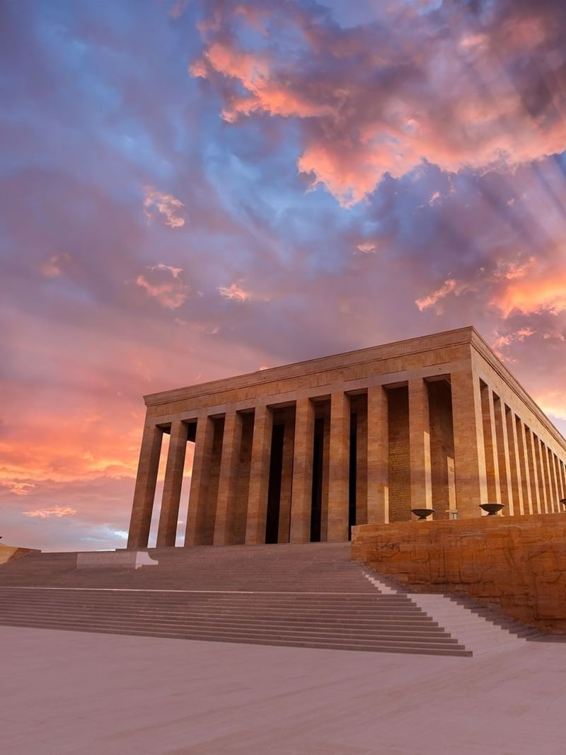Entrance to Anitkabir Monument by wide steps under a dramatic sunset with sun rays near Warwick Ankara