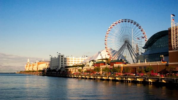 Navy Pier's iconic Ferris wheel and waterfront view with clear blue sky and calm water.
