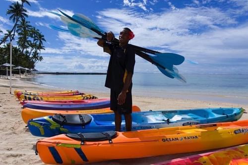 Local man standing on a kayak by the Sea near Warwick Fiji