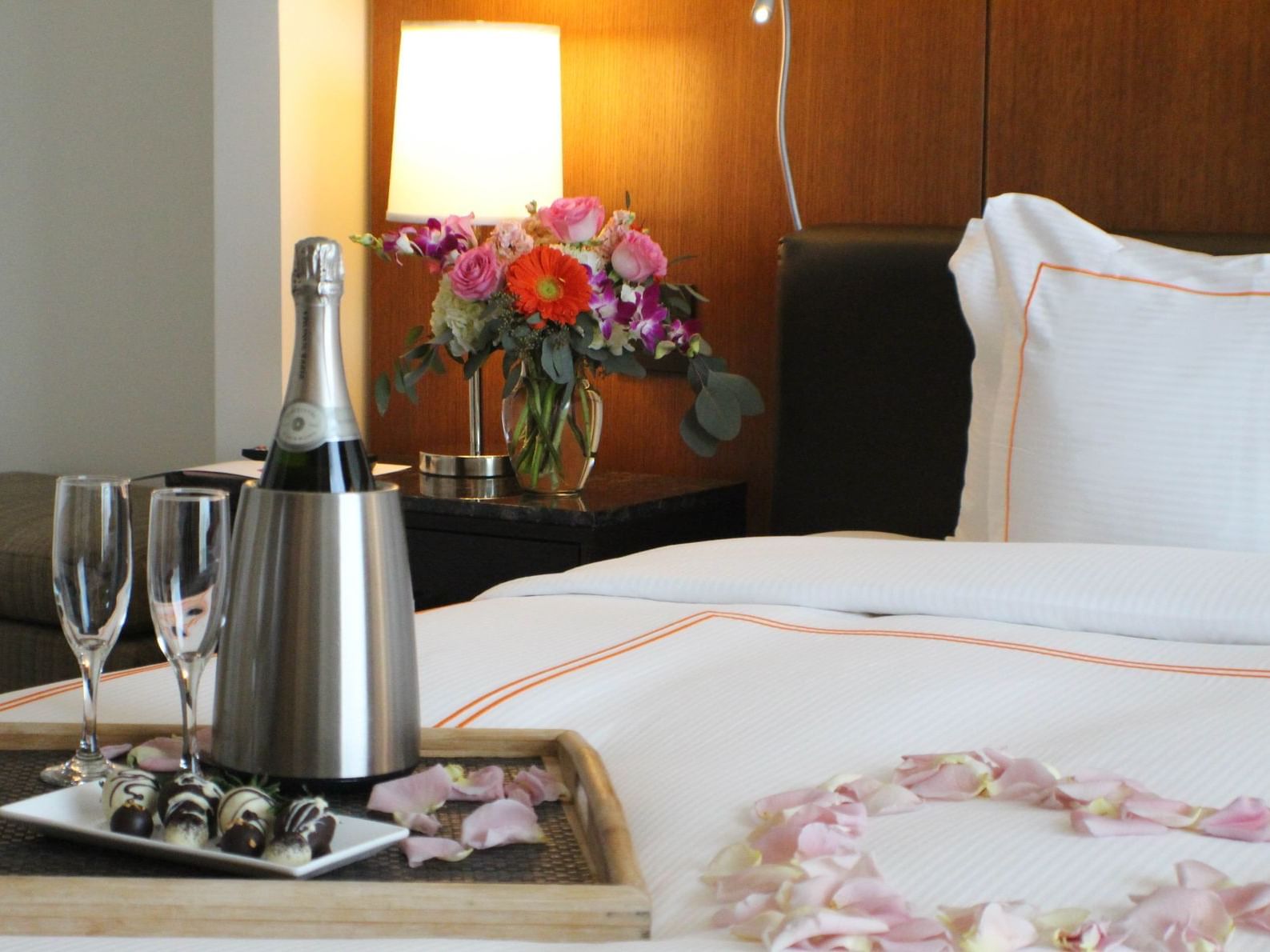 chilled champagne on a hotel bed