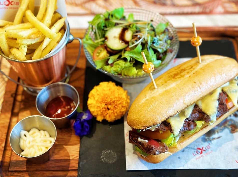 Close-up of a Subway sandwich served with a side of fries & salad near Imperial Lexis Kuala Lumpur