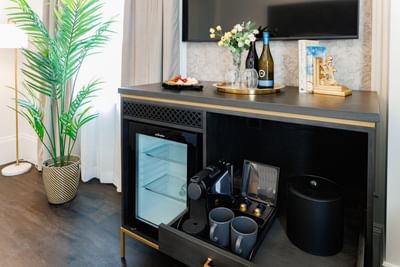 Mini fridge by a coffee machine surrounding a palm tree at Rodd Charlottetown Hotel, a featured Charlottetown hotel room