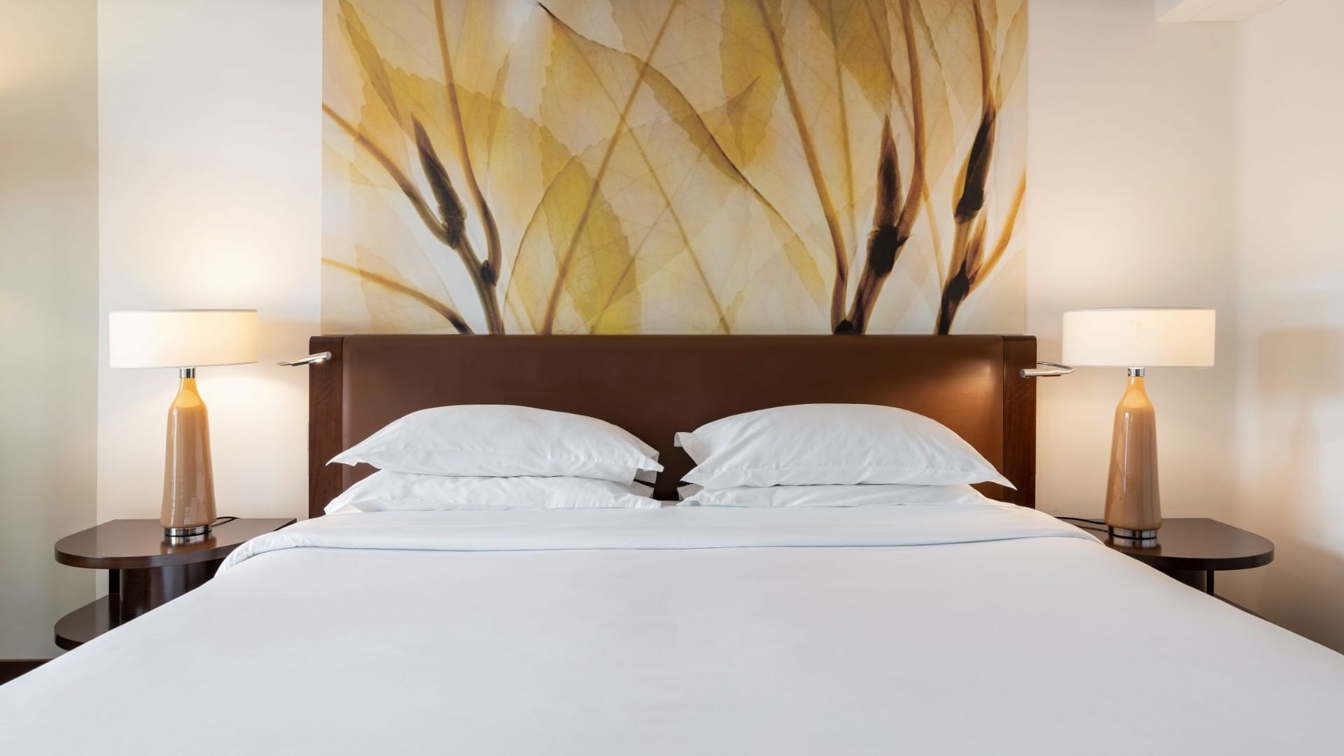 King bed with comfy pillows & bedside lamps in Garden View Room at Terra Nostra Garden Hotel