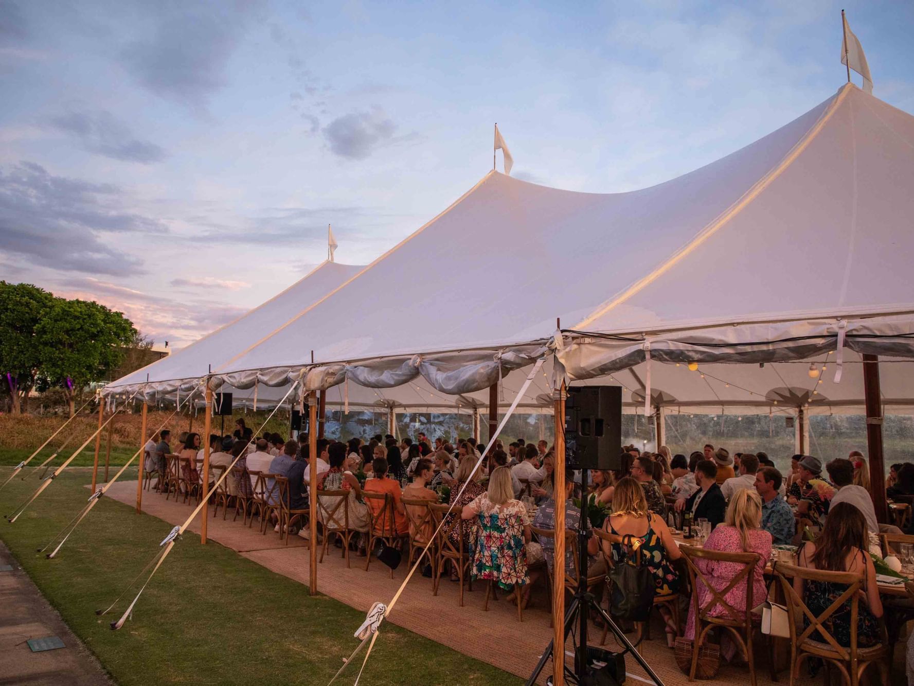 A spacious wedding tent with a crowd at Pullman Magenta Shores