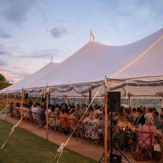 A spacious wedding tent with crowd at Pullman Magenta Shores