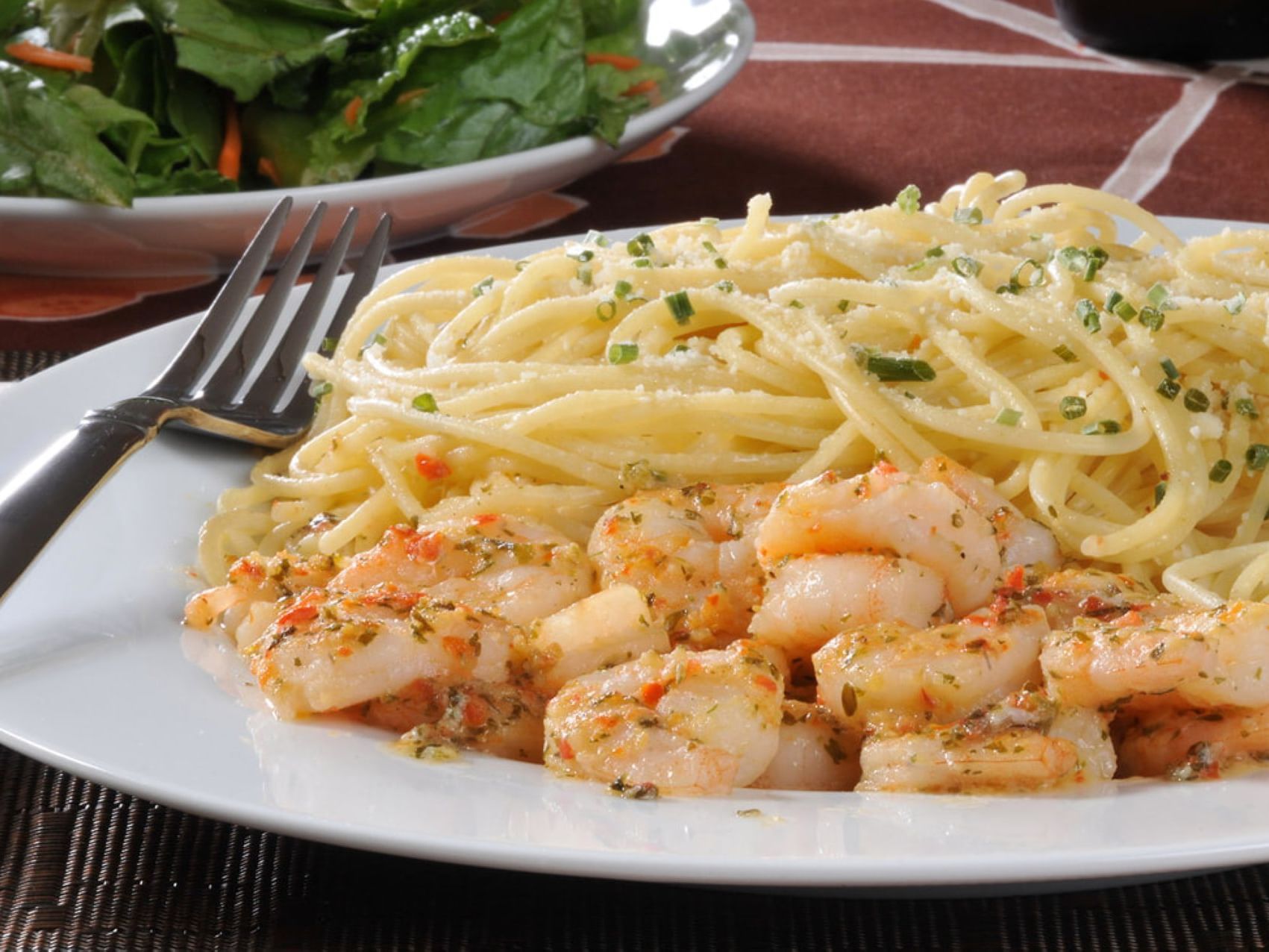 Closeup of a cheesy pasta plate served at MCM Elegante H.O