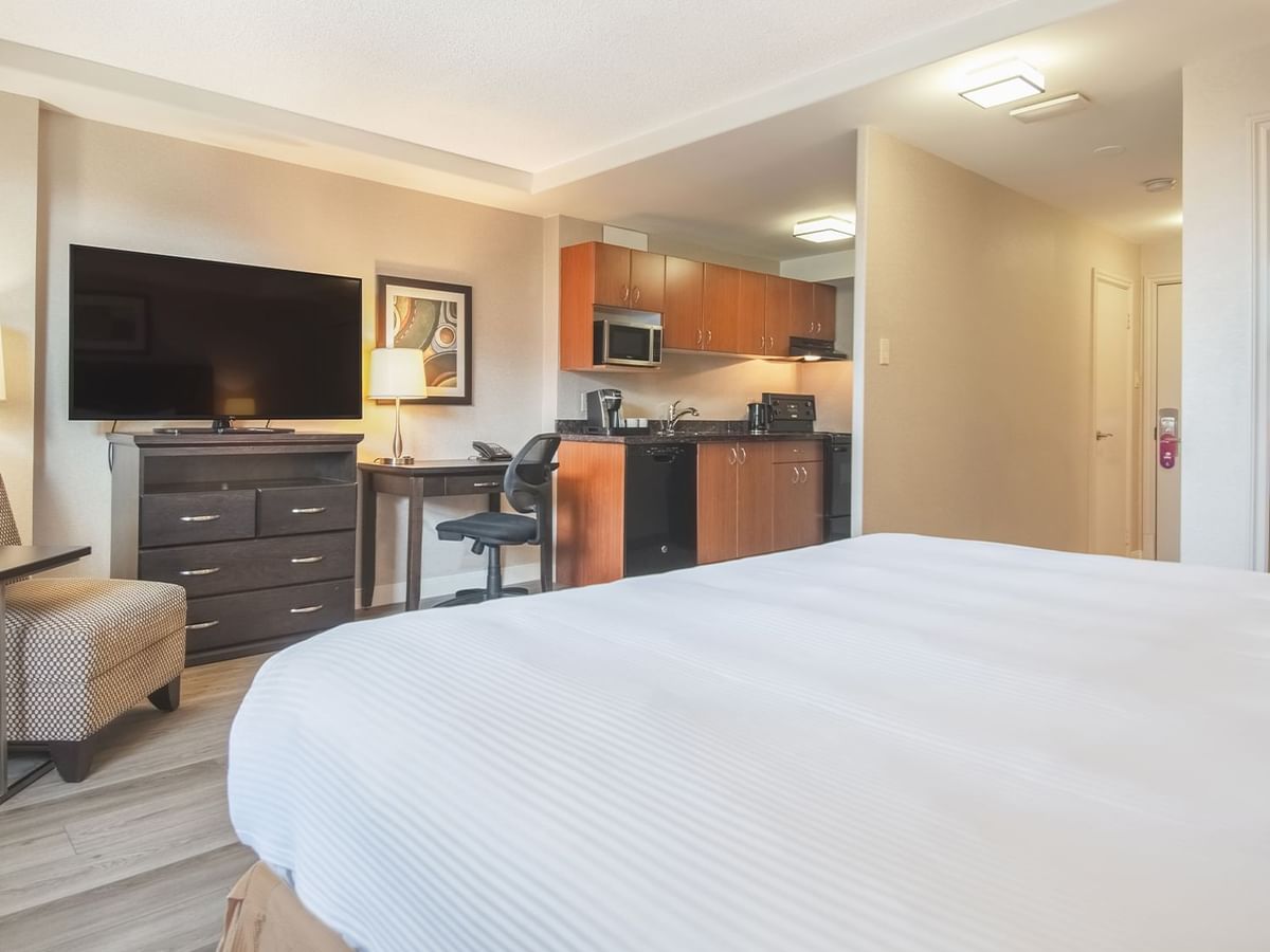 Studio guestroom with king bed, TV, and a kitchen area