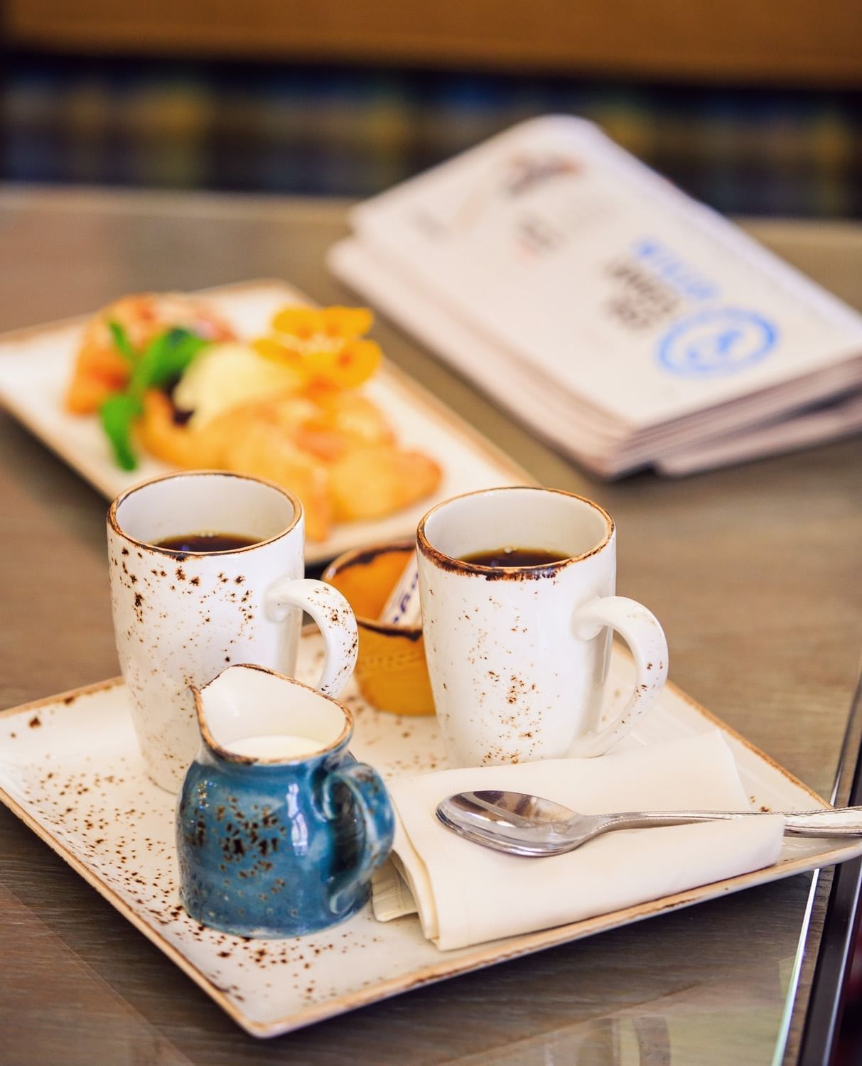 Lorem ipsum A table at the Cello Restaurant with coffee and a folded morning