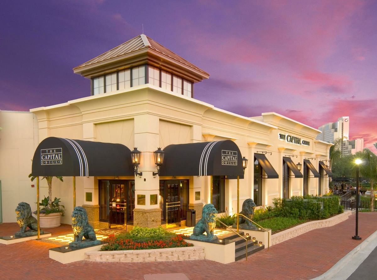 A building with black awnings and lion statues in front of it