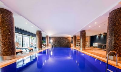 Lounge area by the indoor pool at Amora Hotel Sydney