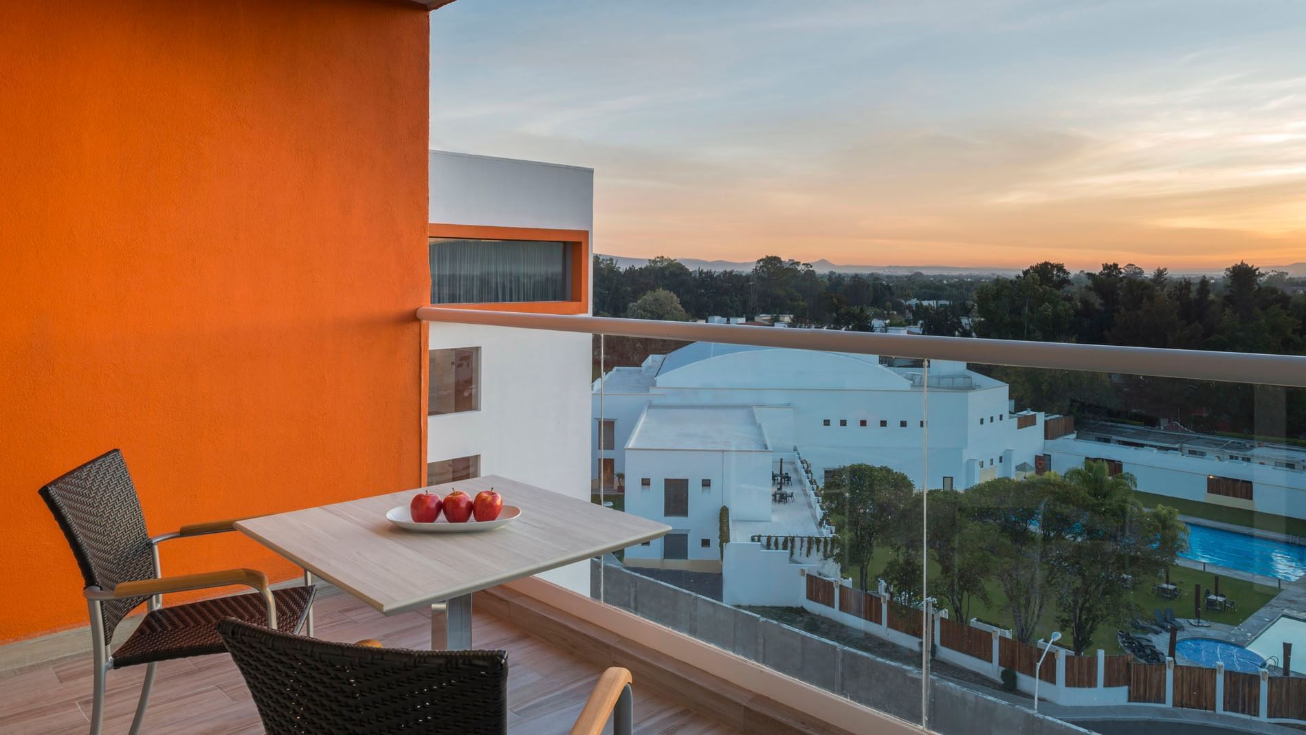 King Junior Suite balcony view at Real Inn Celaya featuring a small table with fruit overlooking the scenic landscape