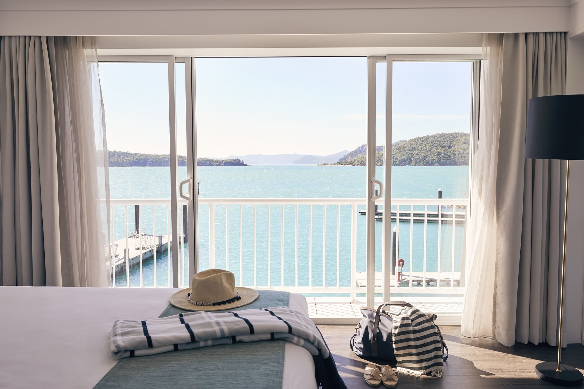 Close up on a king bed with a sun hat at Daydream Island Resort