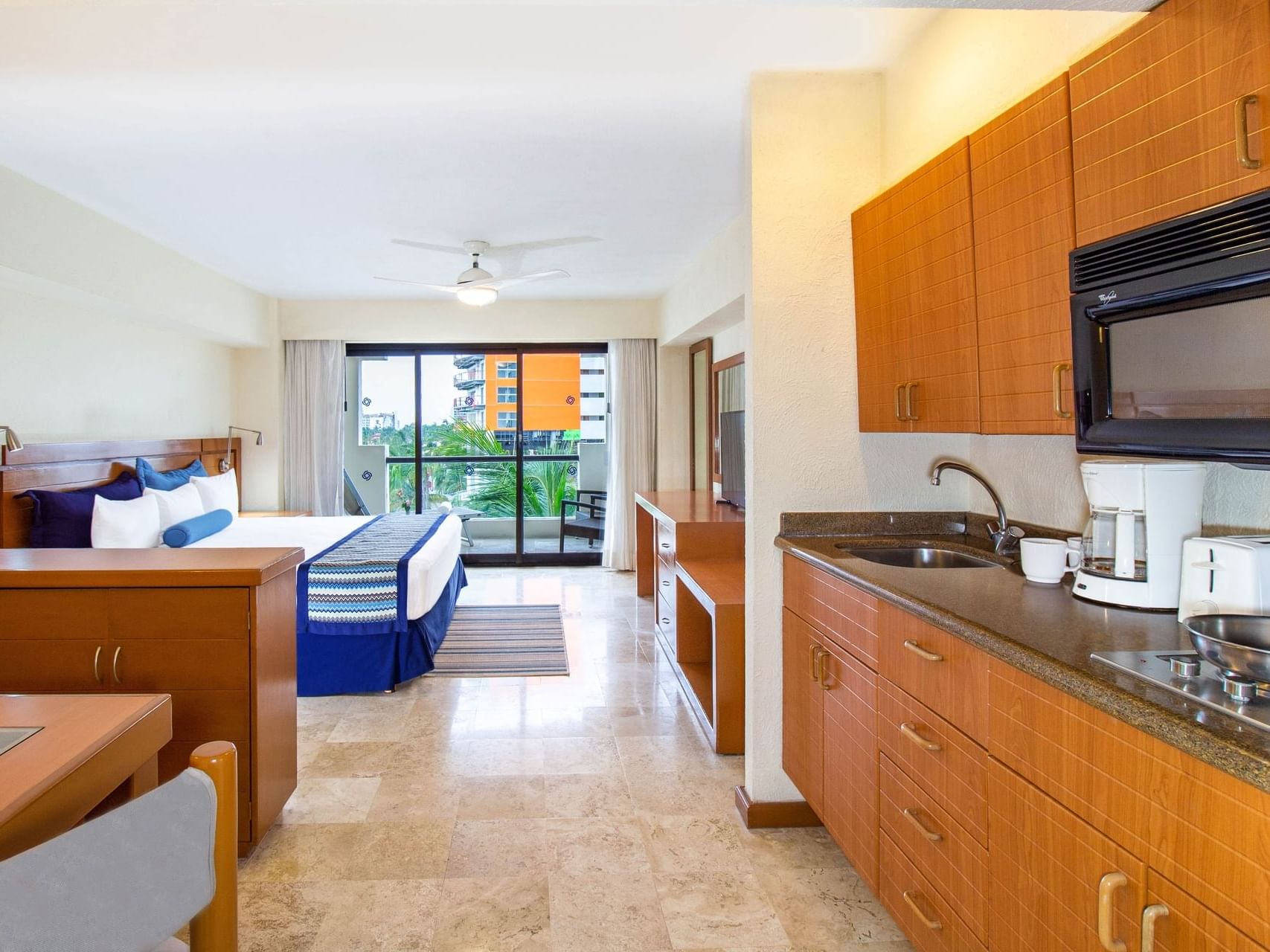 TV facing the bed in King Tower Studio with Kitchen at Plaza Pelicanos Grand Beach Resort