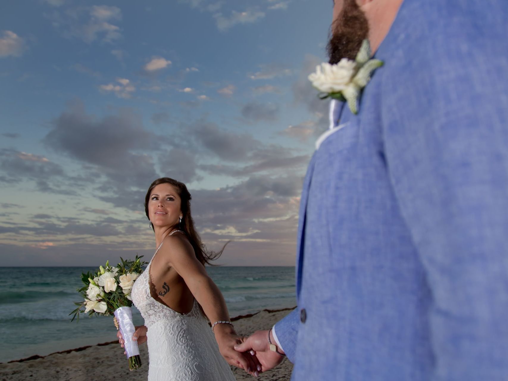 Wedded couple posing by the beach during sunset at Haven Riviera Cancun