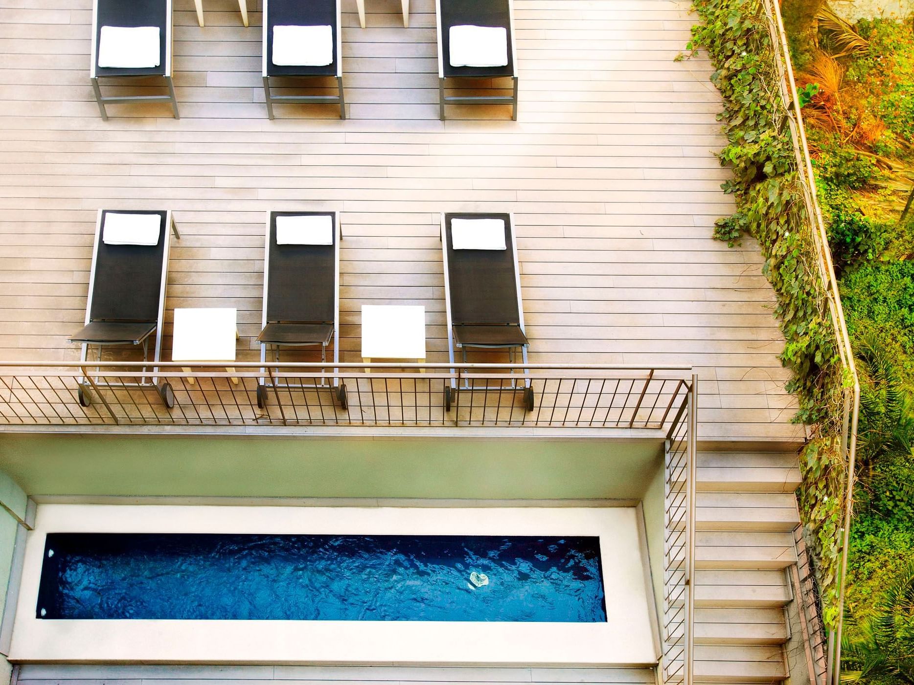 Pool area with lounges at Barcelona Aparthotel Aramunt