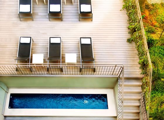 Sunbeds by the outdoor swimming pool at Barcelona Apartment