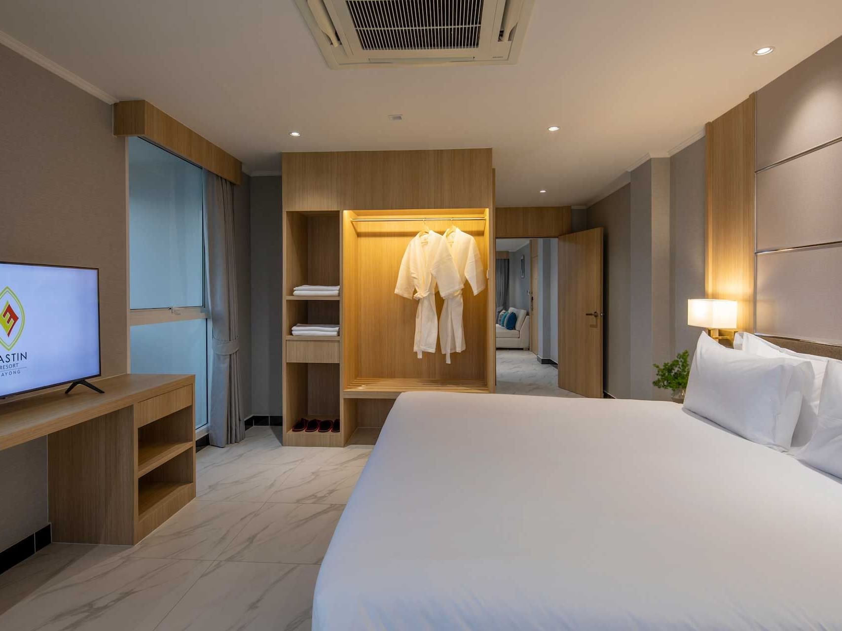 King bed, TV & closet with two bathrobes in Suite Seaview at Eastin Resort Rayong