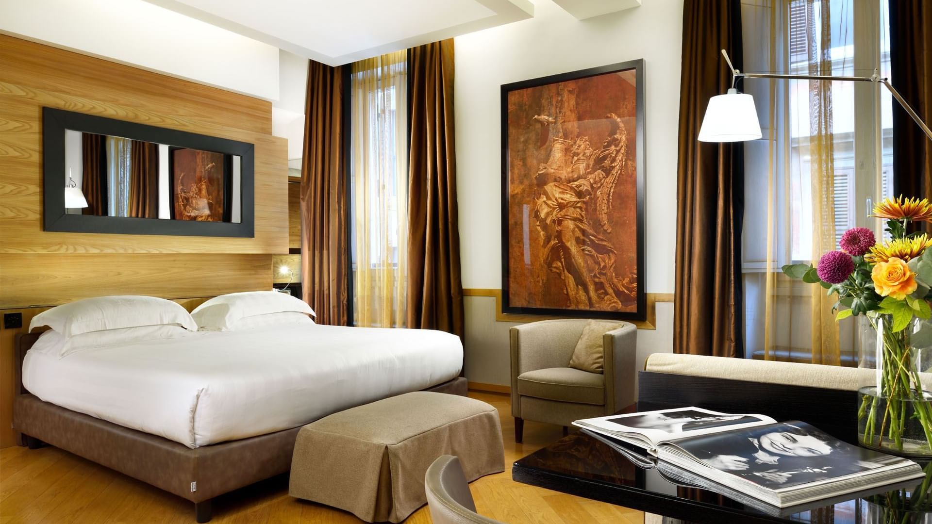 Work desk & TV facing king bed with city view in Classic Suite at Babuino 181
