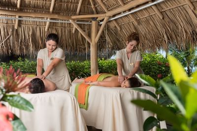Two girls massaging in Heliconia Spa at Fiesta Resort