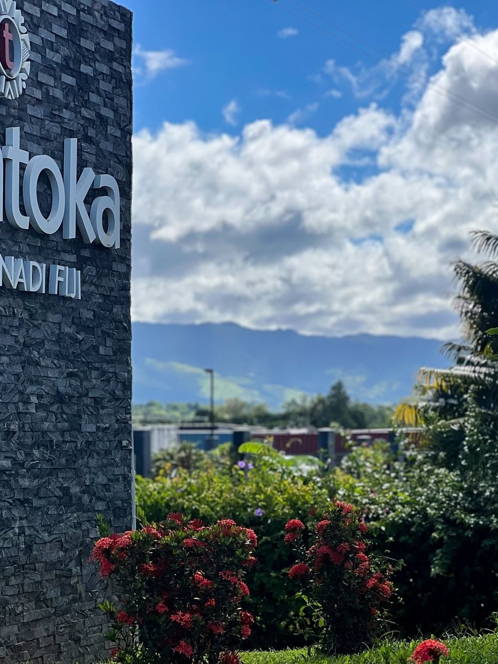 Entrance sign for Tokatoka Resort Nadi Fiji with lush greenery at Tokatoka Resort - Fiji International Airport.