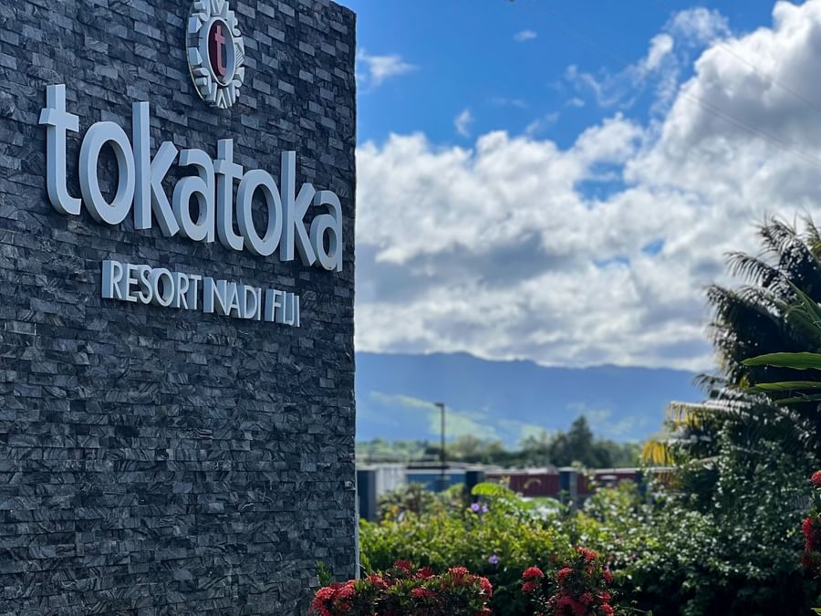 Entrance sign for Tokatoka Resort Nadi Fiji with lush greenery at Tokatoka Resort - Fiji International Airport.