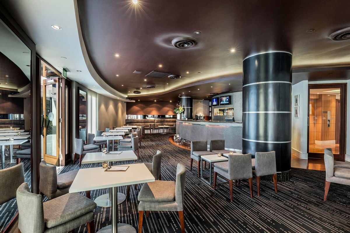 Dining tables arranged in Jarrah Bar & Terrace at Quay West Suites Melbourne