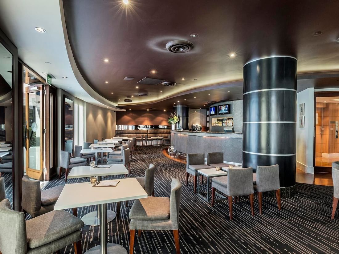 Dining tables arranged in Jarrah Bar & Terrace at Quay West Suites Melbourne