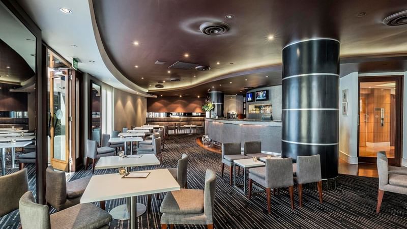 Dining tables arranged in Jarrah Bar & Terrace at Quay West Suites Melbourne