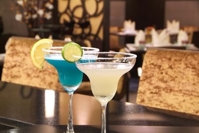 Two glasses of margarita with lime slices at Amora Hotel