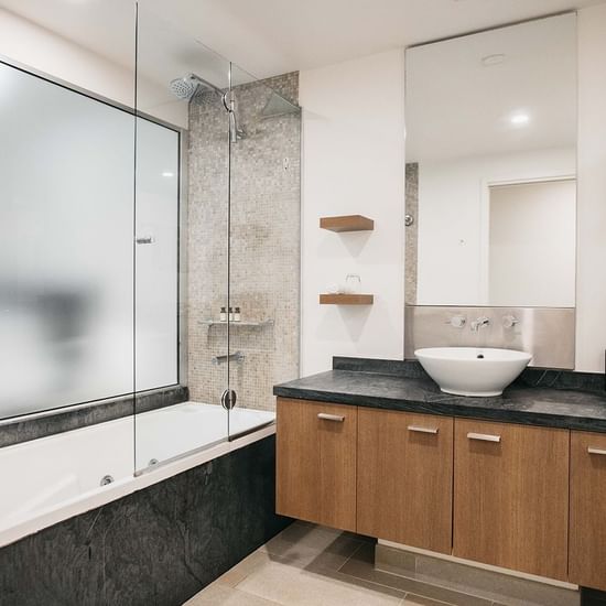 Bathtub, wash basin, and mirror at Pullman Palm Cove Sea Resort