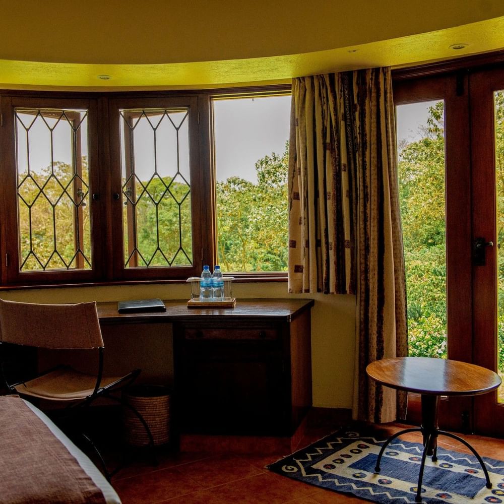 Standard King Room with desk and patio doors to balcony at Arusha Serena Hotel, Arusha.