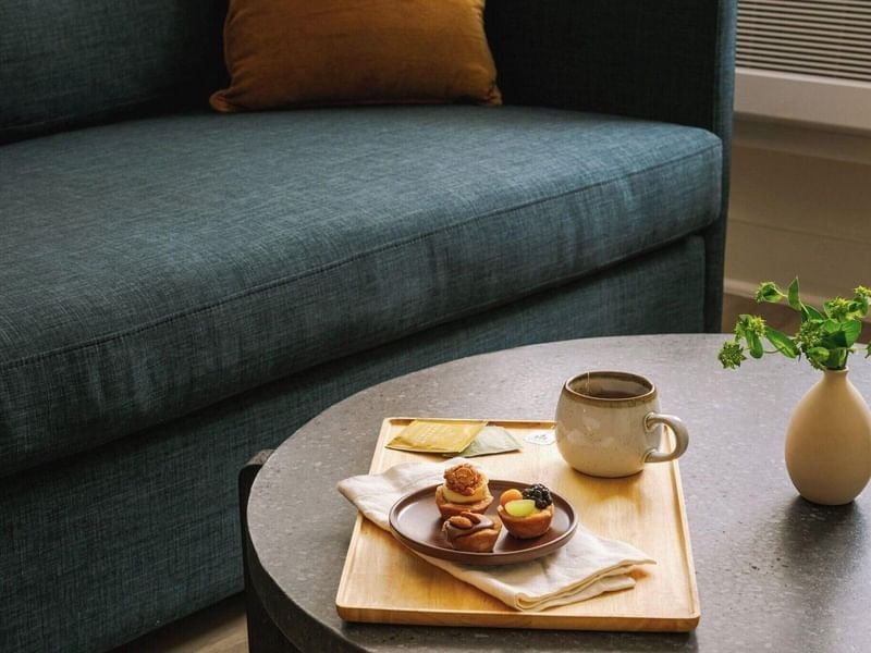 Afternoon cup of tea and plate of sweet pastries served in a room at Kenmore Village Hotel, best hotels in South Beach Miami