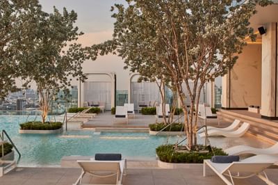Sun loungers by the outdoor pool at Eastin Grand Hotel Phayathai