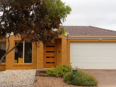 Modern yellow brick house with garage and driveway at La Trobe University Regional Housing – Melton.