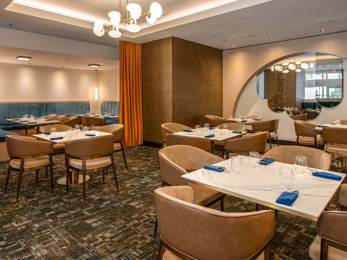Dining space with seating, tables, and elegant lighting.