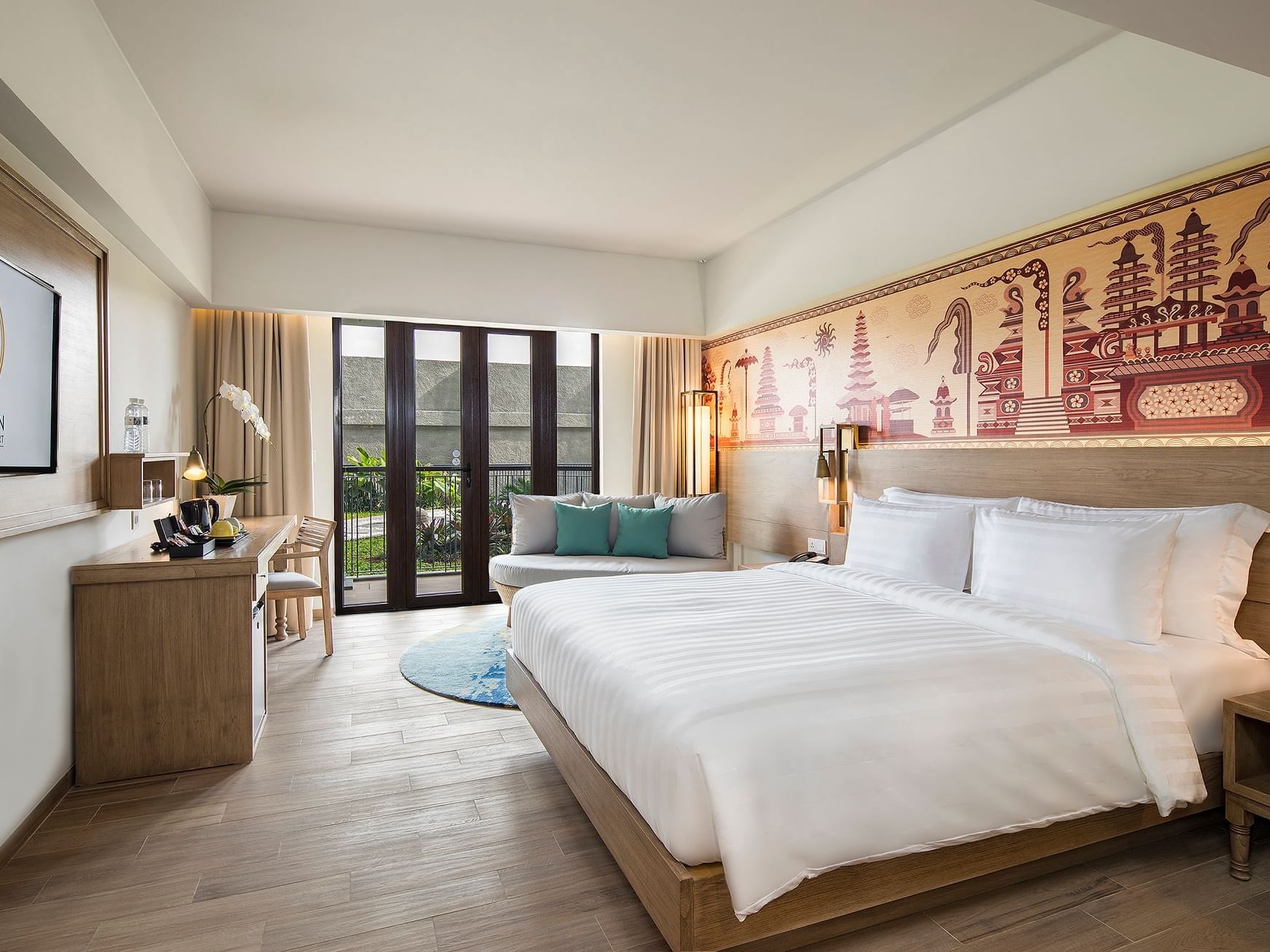 Queen size bed & TV area in Superior Room at Eastin Ashta Resort Canggu