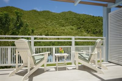 Balcon de la Marina King Bed Suite avec vue sur la montagne au Saint Martin Beach Resort & Spa avec deux chaises et une table