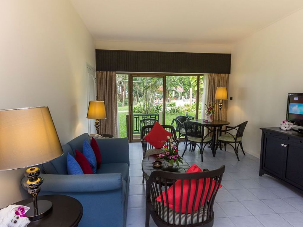 Living area with garden view in Coral Suite at Amora Hotel