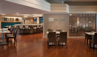 Large hotel restaurant with tabels and bar area