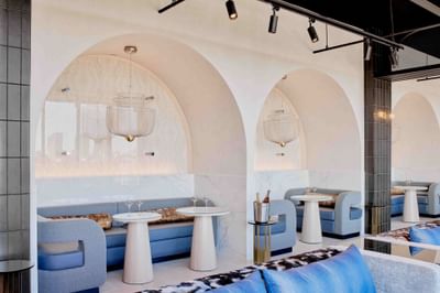 Lavish interior featuring blue & white furniture in IO Rooftop Lounge at Godfrey Hotel Detroit