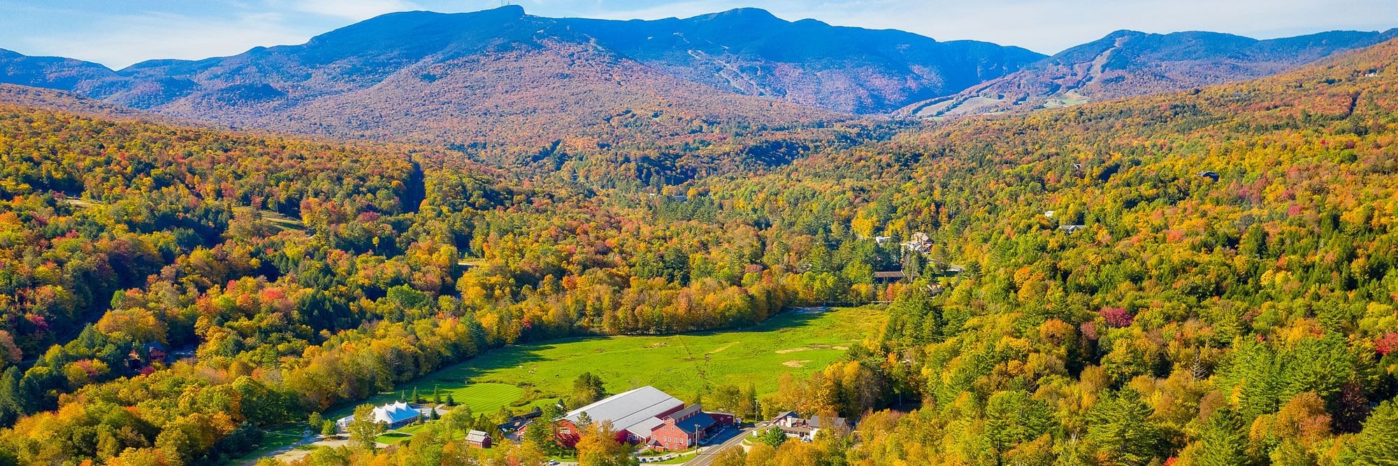 View of Mt. Mansfield and the Green Mountains covered in bright fall foliage.