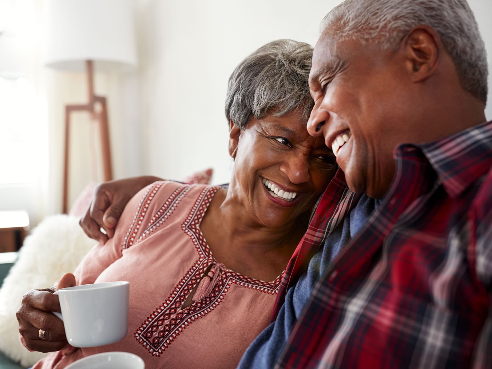 An old couple smiling at each other in Carriage House Hotel
