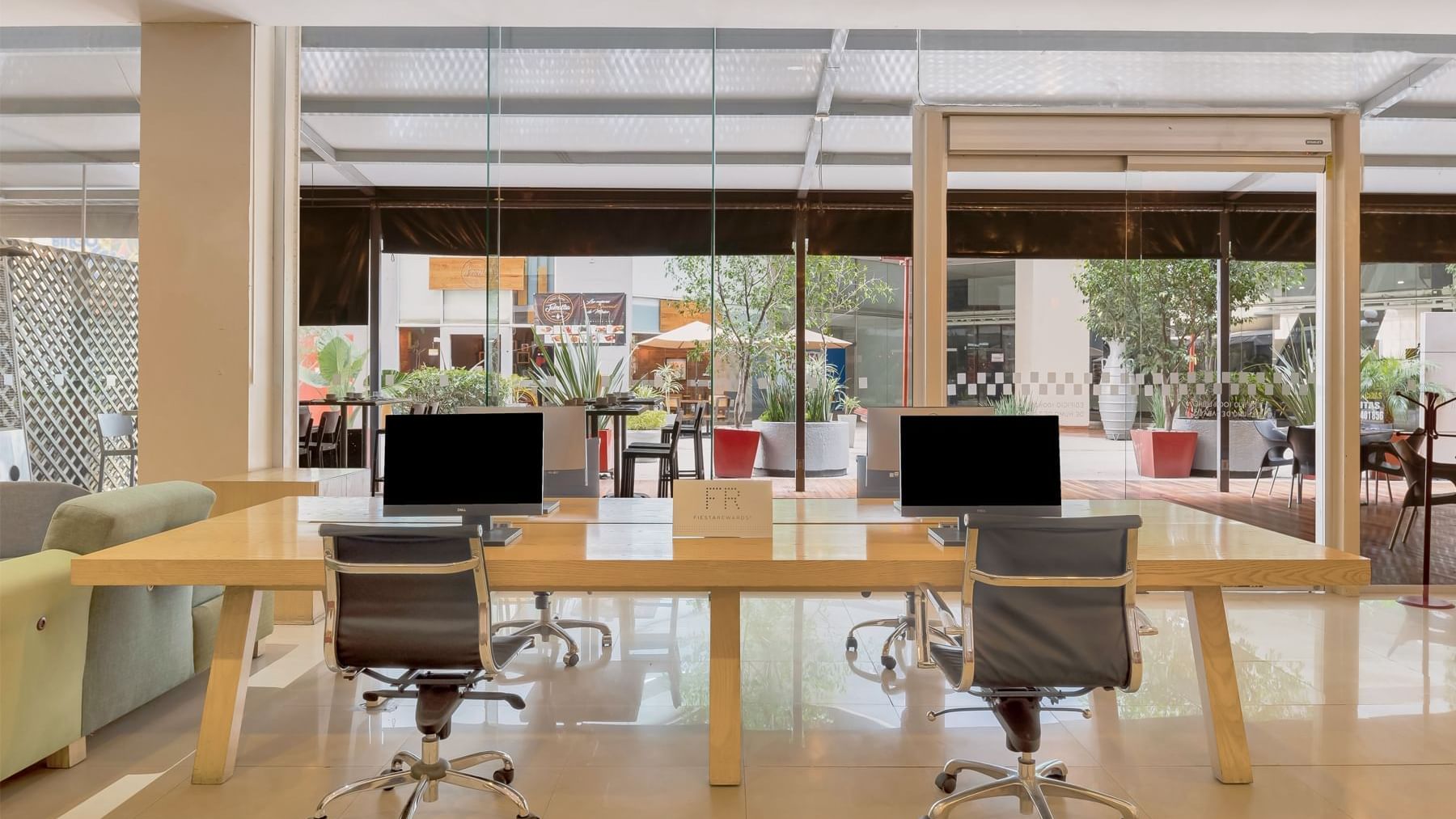 Spacious office with sleek glass wall and desk at Fiesta Inn